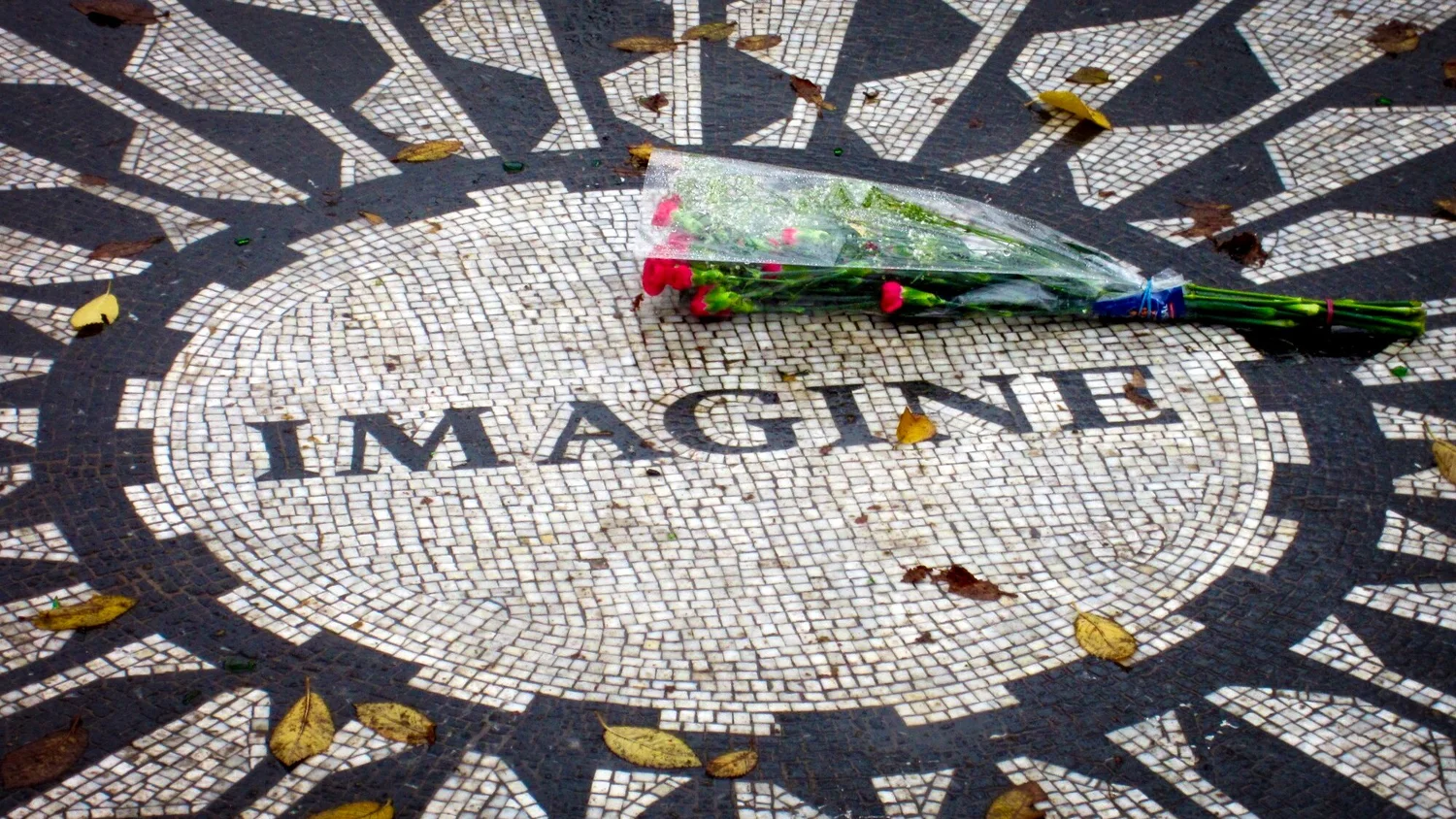 The Imagine mosaic at Strawberry Fields in Central Park with a bouquet of flowers resting on it